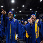 Two college graduates yelling in excitement